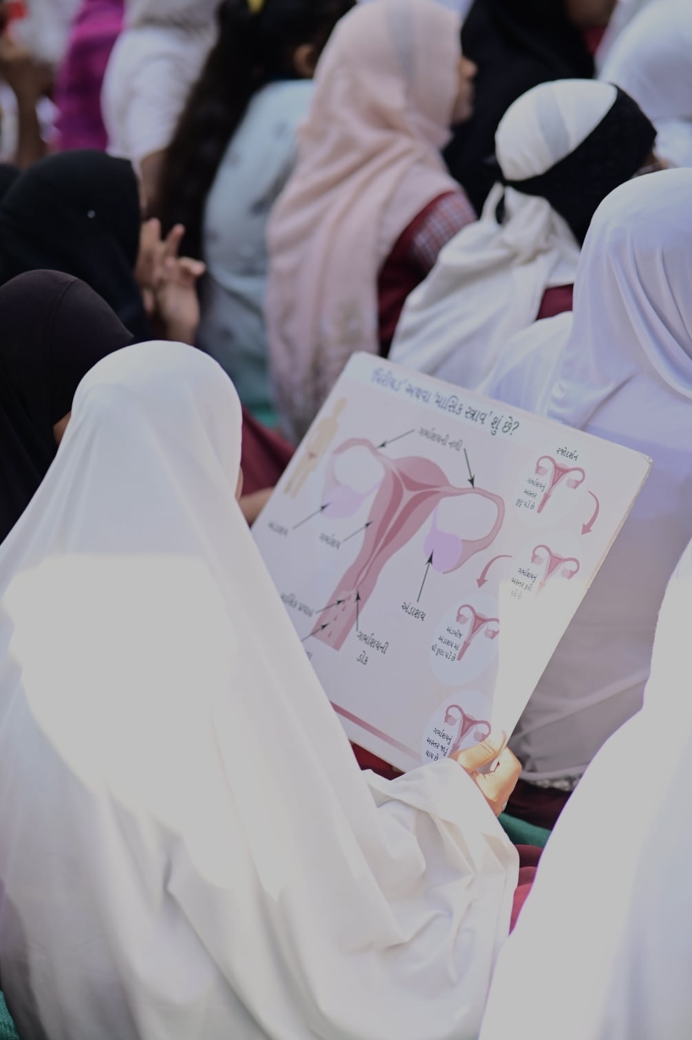 Community education session on menstrual health with educational materials